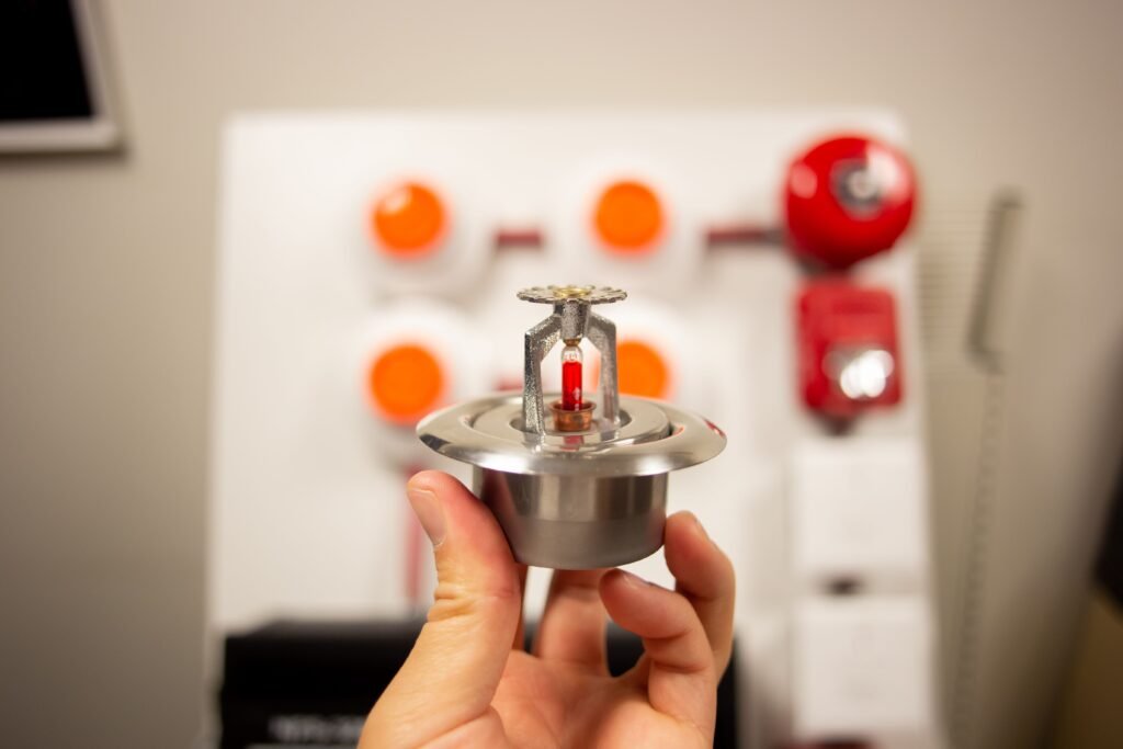 Fire sensor held up by a fire alarm engineer