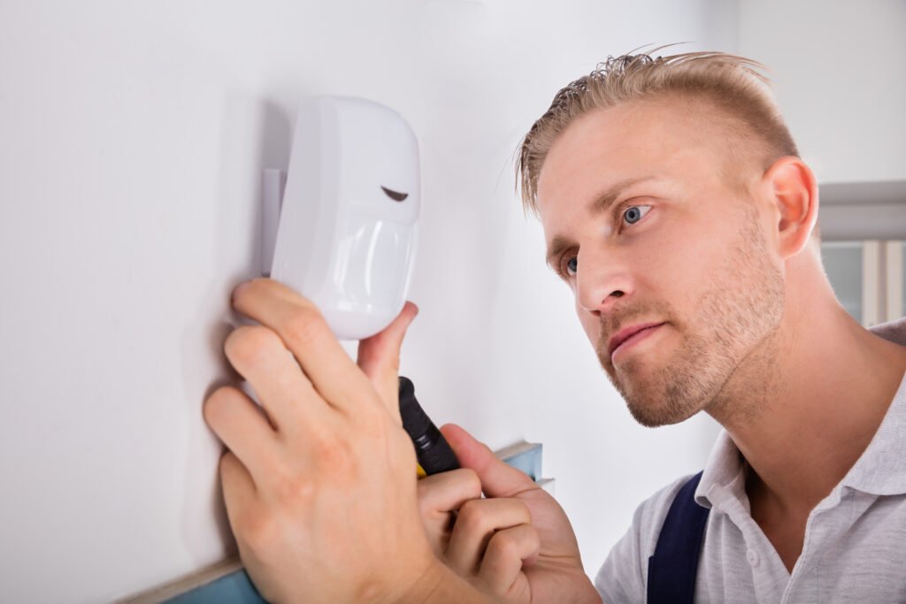 Security subcontractor installing detector