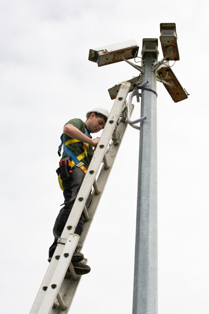 CCTV Engineer working on a ladder